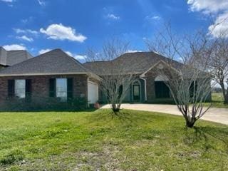 single story home featuring a front yard and a garage