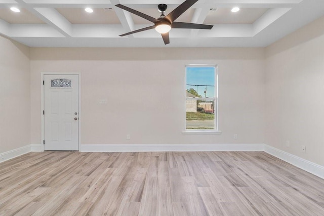 empty room with coffered ceiling, light hardwood / wood-style floors, ceiling fan, and beamed ceiling