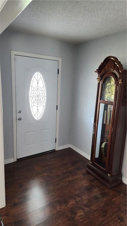 entryway with dark hardwood / wood-style flooring and a textured ceiling