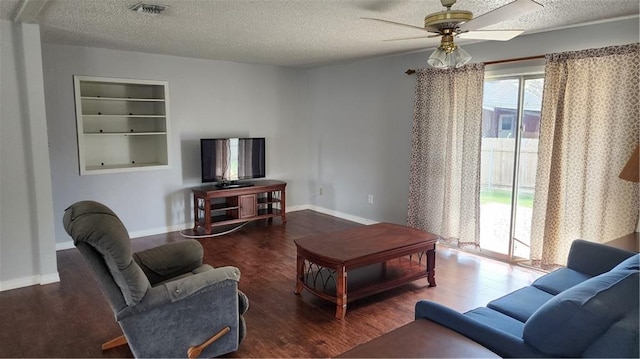 living room with hardwood / wood-style floors, ceiling fan, a textured ceiling, and built in features