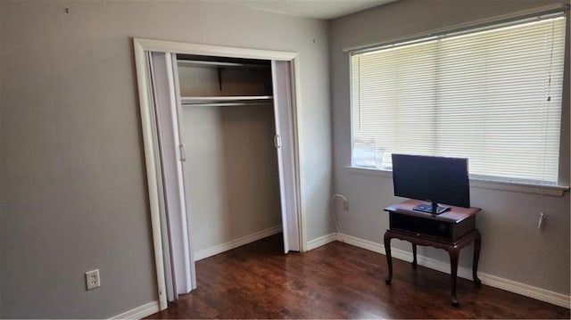 bedroom featuring a closet and dark hardwood / wood-style flooring