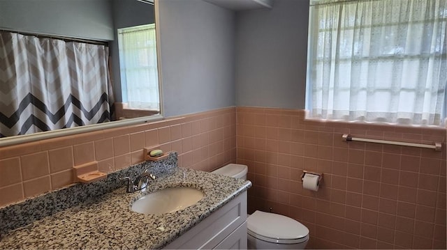 bathroom featuring tile walls, a wealth of natural light, and tasteful backsplash