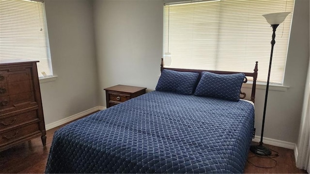 bedroom with dark hardwood / wood-style flooring