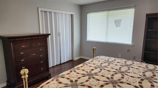 bedroom with dark hardwood / wood-style flooring