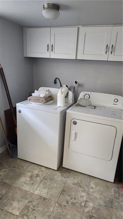 laundry room with washing machine and clothes dryer, hookup for an electric dryer, cabinets, and light tile floors