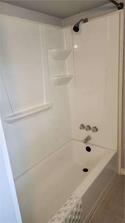 bathroom featuring bathtub / shower combination and tile flooring