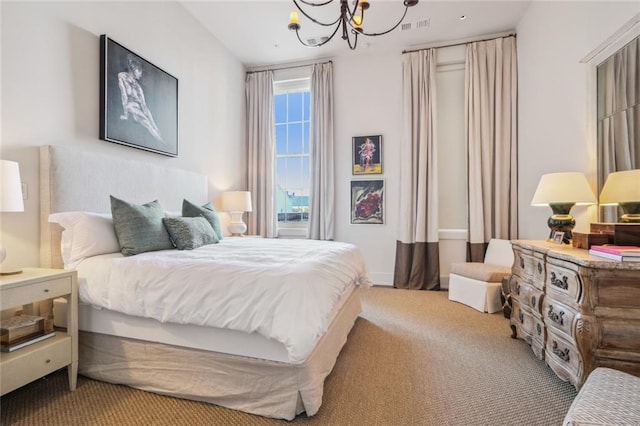 bedroom featuring an inviting chandelier and carpet flooring