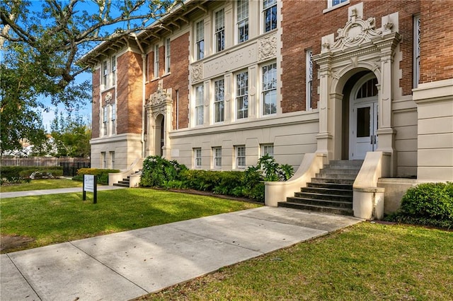 doorway to property with a lawn