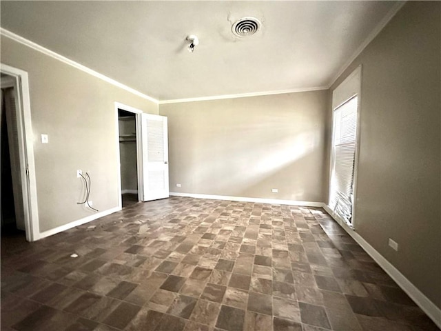 tiled empty room featuring ornamental molding