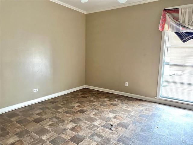 unfurnished room featuring dark tile floors and ornamental molding