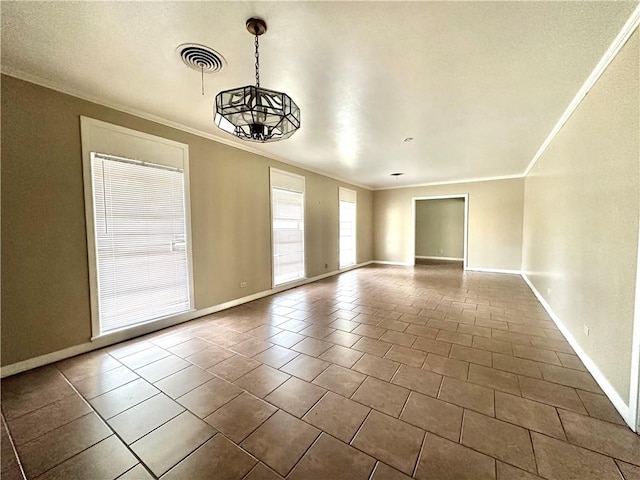 tiled empty room featuring a chandelier and crown molding