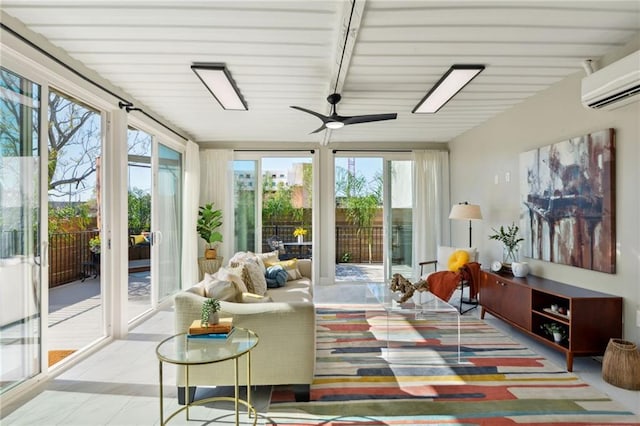 sunroom / solarium with beam ceiling, a wall mounted AC, and ceiling fan