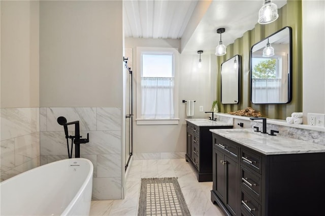 bathroom with plenty of natural light, tile flooring, double vanity, and a bath to relax in