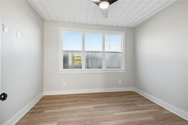 spare room featuring light hardwood / wood-style floors and ceiling fan