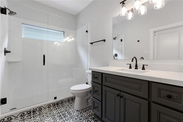 bathroom with an enclosed shower, tile flooring, vanity with extensive cabinet space, and toilet