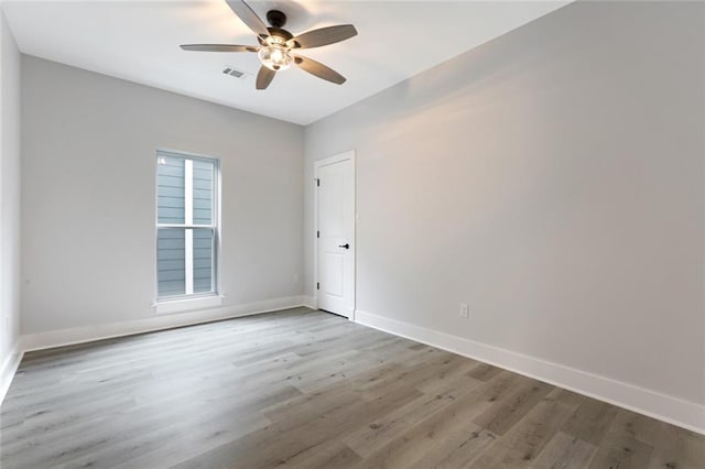 spare room featuring light hardwood / wood-style floors and ceiling fan