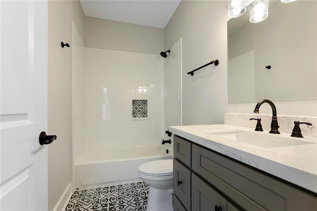 full bathroom with large vanity, tile floors, toilet, and tiled shower / bath