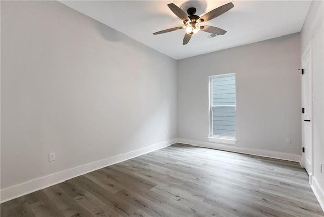 empty room featuring ceiling fan and light wood-type flooring