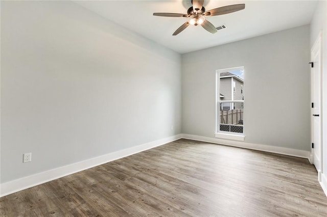 unfurnished room featuring hardwood / wood-style flooring, plenty of natural light, and ceiling fan