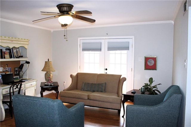 living room featuring wood-type flooring, ceiling fan, and crown molding