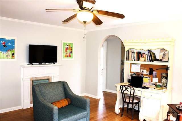 office area with dark wood-type flooring, ceiling fan, and crown molding