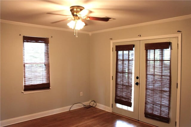 entryway featuring dark hardwood / wood-style flooring, a wealth of natural light, french doors, and crown molding