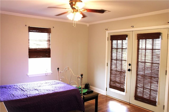 bedroom featuring ornamental molding, multiple windows, wood-type flooring, and ceiling fan