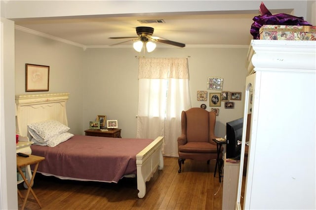 bedroom with hardwood / wood-style flooring, ceiling fan, and ornamental molding