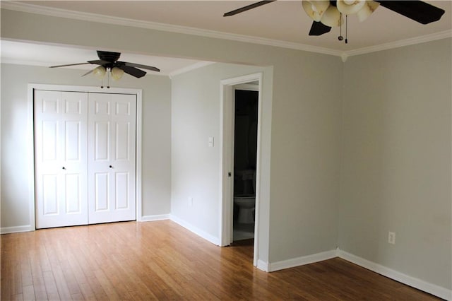 unfurnished bedroom featuring hardwood / wood-style flooring, ceiling fan, a closet, and ornamental molding