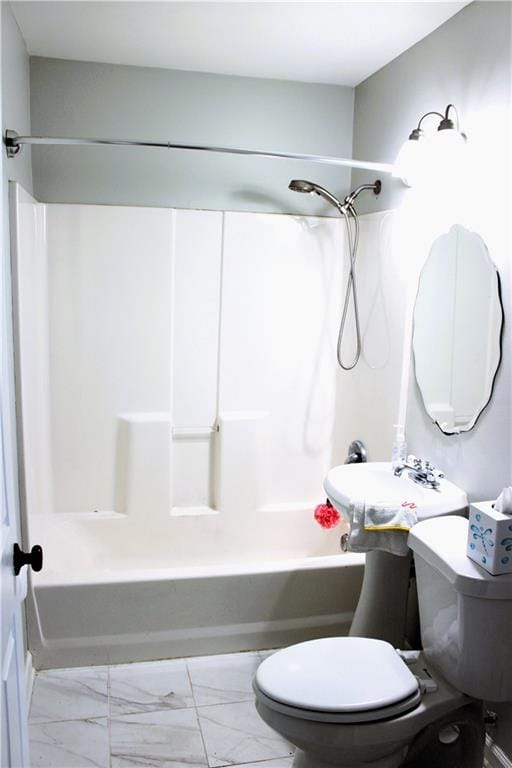 bathroom featuring toilet and shower / bathtub combination