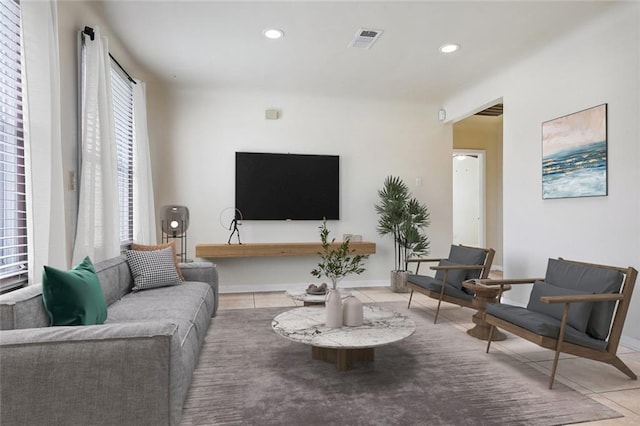 tiled living room featuring a healthy amount of sunlight