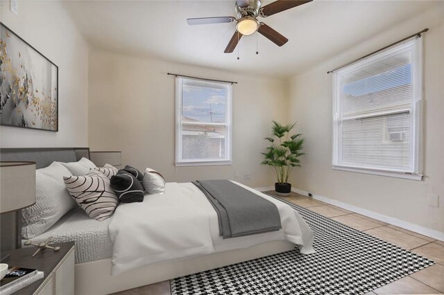 bedroom featuring light tile patterned flooring and ceiling fan