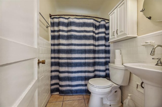 bathroom with decorative backsplash, tile walls, tile patterned floors, and toilet