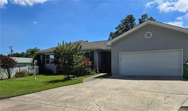 ranch-style house with a garage and a front lawn