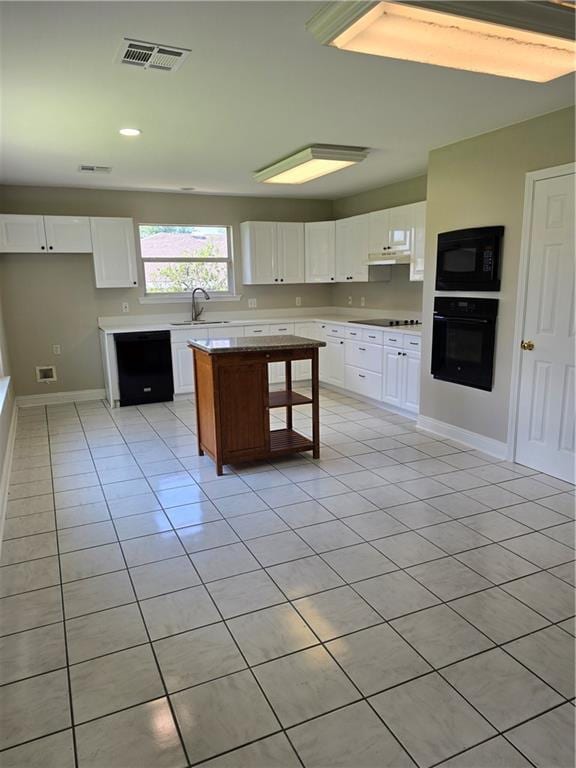 kitchen featuring white cabinets, a center island, sink, and black appliances