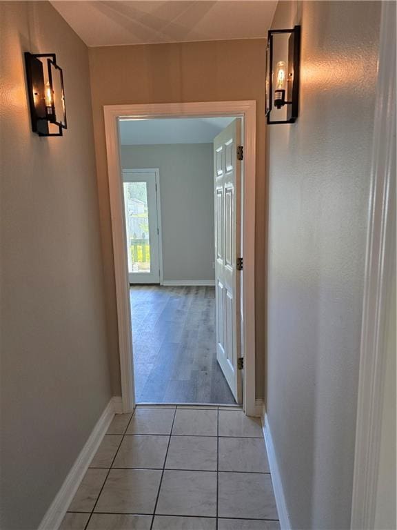 hall with light tile patterned floors