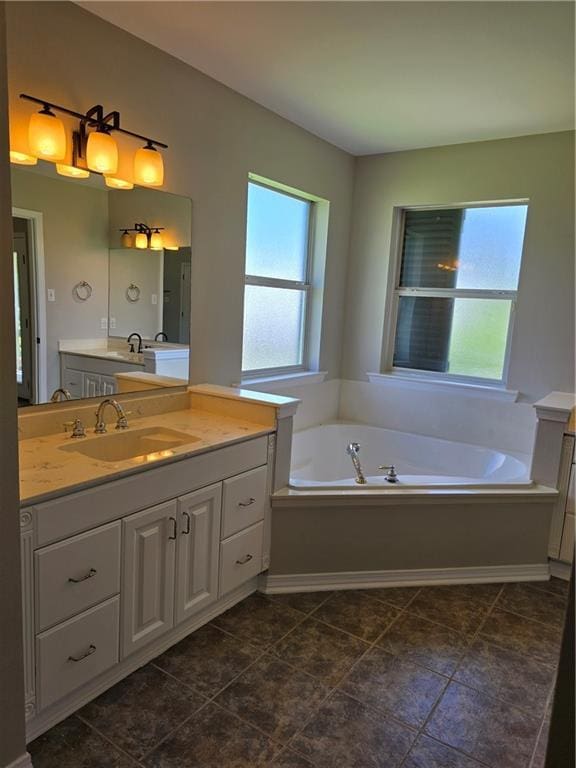 bathroom featuring a tub to relax in and vanity