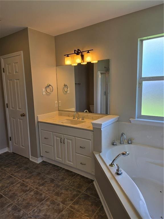 bathroom with vanity and separate shower and tub