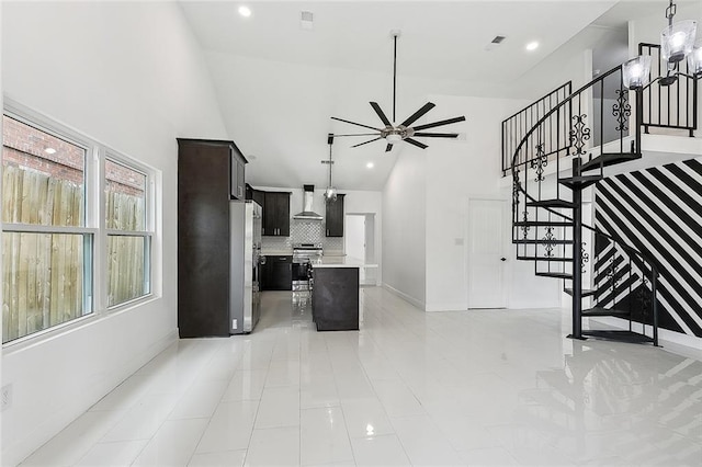 living room featuring ceiling fan and high vaulted ceiling