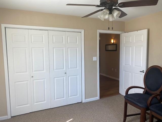 sitting room featuring carpet floors and ceiling fan