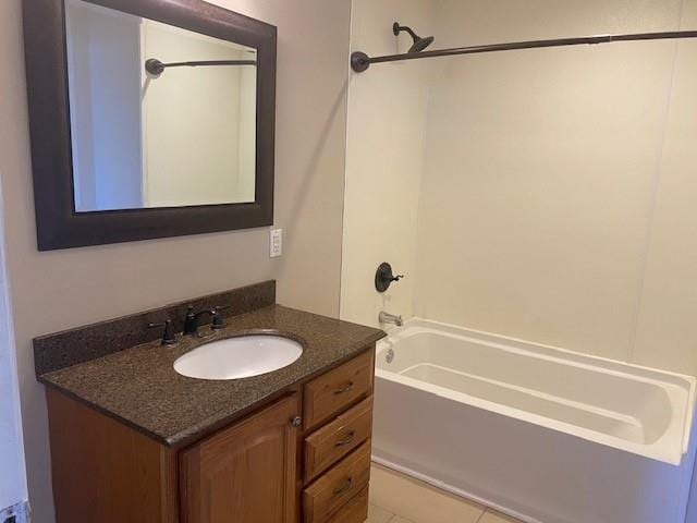 bathroom featuring bathtub / shower combination, tile patterned floors, and vanity