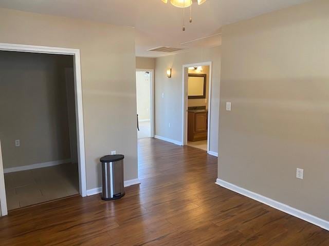 empty room with dark wood-type flooring