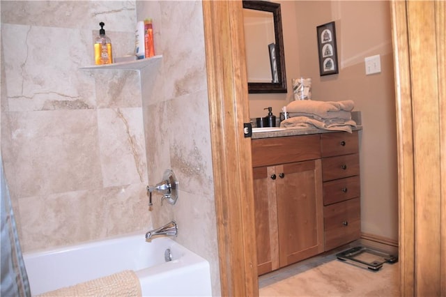 bathroom with vanity and tiled shower / bath