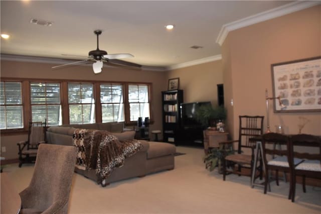 carpeted living room with crown molding and ceiling fan