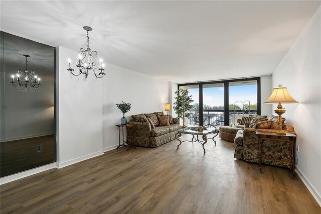 living room with floor to ceiling windows, dark wood-type flooring, and a notable chandelier