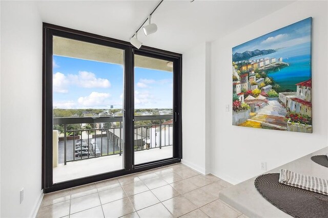 entryway with light tile patterned floors and floor to ceiling windows