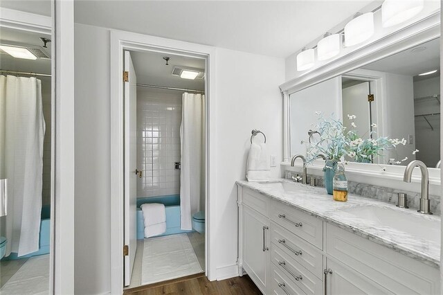 bathroom with vanity, hardwood / wood-style flooring, and walk in shower