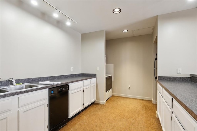 kitchen featuring black dishwasher, dark countertops, a sink, and white cabinets