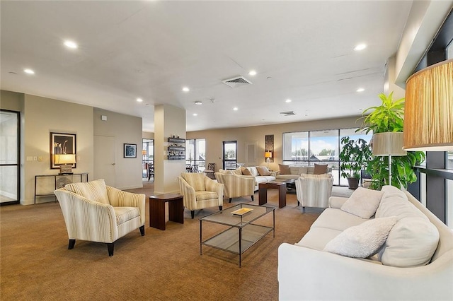 living area with carpet, visible vents, and recessed lighting