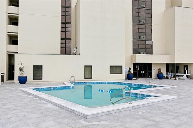 view of swimming pool with a patio area